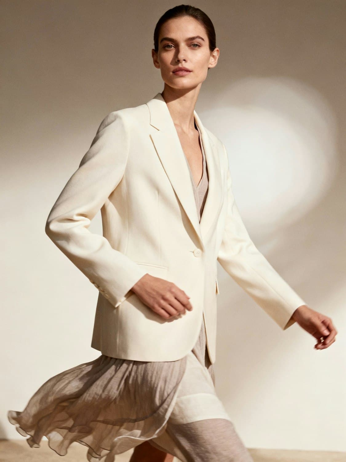 Portrait of a team member in a cream blazer